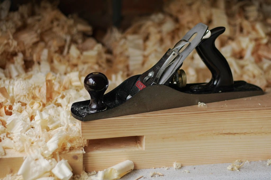 Well-kept hand tools on a workbench — the model is one tool in the system, not the system